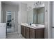 Bathroom with double sink vanity and a view into the main bedroom at 4001 N 300Th Ln, Buckeye, AZ 85396