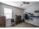 Bedroom with neutral walls features a closet, dresser, and a ceiling fan at 4001 N 300Th Ln, Buckeye, AZ 85396