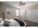Neutral bedroom featuring a ceiling fan, window, closet, and cozy bed with stylish gray accents at 4001 N 300Th Ln, Buckeye, AZ 85396