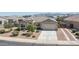Well-maintained single-story home with desert landscaping, a two-car garage, and a tile roof at 4001 N 300Th Ln, Buckeye, AZ 85396