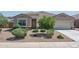 Inviting home exterior with well-maintained gravel landscaping and a charming front entrance at 4001 N 300Th Ln, Buckeye, AZ 85396