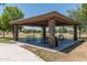 Covered picnic area with stone columns, offering a shaded space for gatherings and outdoor dining at 4001 N 300Th Ln, Buckeye, AZ 85396