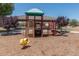 Well-equipped playground featuring various slides and play structures in a wood chip safety area at 4001 N 300Th Ln, Buckeye, AZ 85396