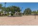 Sand volleyball court with a gazebo and tables, perfect for outdoor recreation and relaxation at 4001 N 300Th Ln, Buckeye, AZ 85396