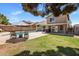 Inviting backyard features a pool, patio, manicured lawn, and outdoor seating area for relaxation and entertainment at 4118 W Fallen Leaf Ln, Glendale, AZ 85310