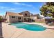 Spacious backyard featuring a pool, diving board, patio, and lush lawn is perfect for outdoor living at 4118 W Fallen Leaf Ln, Glendale, AZ 85310