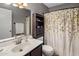 Clean and well-maintained bathroom features a single sink vanity, neutral colors, and a shower/tub combo with curtain at 4118 W Fallen Leaf Ln, Glendale, AZ 85310