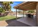 The covered patio features outdoor seating with views of the pool and well-maintained backyard at 4118 W Fallen Leaf Ln, Glendale, AZ 85310