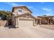 Two-story home featuring an attached two-car garage, driveway, and walkway to the front entrance at 4118 W Fallen Leaf Ln, Glendale, AZ 85310