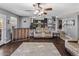 Cozy living area with hardwood floors, accent bar, and stairs leading to a second level at 4118 W Fallen Leaf Ln, Glendale, AZ 85310
