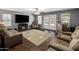Spacious living room featuring hardwood floors, a fireplace, and comfortable seating at 4118 W Fallen Leaf Ln, Glendale, AZ 85310