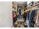 Walk-in closet with custom shelving and hanging rods, providing ample storage space for clothing and accessories at 4118 W Fallen Leaf Ln, Glendale, AZ 85310