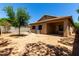 An outdoor area with a cozy covered patio and low-maintenance landscaping at 4216 N Dania Ct, Litchfield Park, AZ 85340