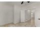 Bright bedroom with a ceiling fan, light walls, and neutral tile flooring at 4216 N Dania Ct, Litchfield Park, AZ 85340