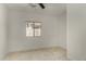 An airy bedroom featuring neutral colored tile flooring and a window letting in natural light at 4216 N Dania Ct, Litchfield Park, AZ 85340