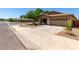 Charming single-story home featuring a well-maintained front yard and a two-car garage at 4216 N Dania Ct, Litchfield Park, AZ 85340