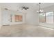 Bright and spacious living room featuring tile floors, a ceiling fan, and natural light at 4216 N Dania Ct, Litchfield Park, AZ 85340