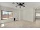 Bright living room features tile flooring, a ceiling fan, and backyard access at 4216 N Dania Ct, Litchfield Park, AZ 85340