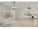 Bright and spacious living room featuring tile floors, a ceiling fan, and natural light at 4216 N Dania Ct, Litchfield Park, AZ 85340