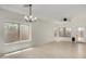 Bright and spacious living room featuring tile floors, a ceiling fan, and natural light at 4216 N Dania Ct, Litchfield Park, AZ 85340