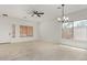 Bright and spacious living room featuring tile floors, a ceiling fan, and natural light at 4216 N Dania Ct, Litchfield Park, AZ 85340