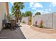 Backyard patio features a dining table and chairs, as well as a manicured garden at 4420 E Amberwood Dr, Phoenix, AZ 85048