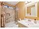 Bright bathroom features a vanity sink and shower-over-tub with tiled walls at 4420 E Amberwood Dr, Phoenix, AZ 85048