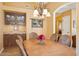 Charming dining room featuring a wooden table, chandelier, and built-in cabinet at 4420 E Amberwood Dr, Phoenix, AZ 85048