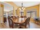 Inviting dining room with a chandelier and views into the living room and fireplace at 4420 E Amberwood Dr, Phoenix, AZ 85048