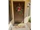Inviting front door with colorful floral wreath and 'Welcome' mat creates a warm and welcoming entrance to the home at 4420 E Amberwood Dr, Phoenix, AZ 85048