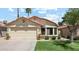 Charming single-story home with a two-car garage, manicured lawn, and a lovely bay window at 4420 E Amberwood Dr, Phoenix, AZ 85048