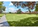 A winding path leads through lush community greenspace with mature trees offering shade, perfect for walking and enjoying nature at 4420 E Amberwood Dr, Phoenix, AZ 85048
