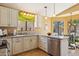 Well-lit kitchen featuring granite countertops, stainless steel dishwasher, and wood-look flooring at 4420 E Amberwood Dr, Phoenix, AZ 85048