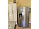 Modern kitchen with a stainless steel refrigerator and white pantry for storing food at 4420 E Amberwood Dr, Phoenix, AZ 85048