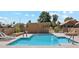 Refreshing community pool with clear blue water, poolside chairs and a small storage building surrounded by well-maintained landscaping at 4420 E Amberwood Dr, Phoenix, AZ 85048