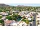 Aerial view of the neighborhood with lush landscaping, community pool, and picturesque mountain backdrop at 4525 N 66Th St # 85, Scottsdale, AZ 85251