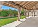 Relaxing covered patio with sheer curtains, offering shade and privacy in a serene outdoor setting at 4525 N 66Th St # 85, Scottsdale, AZ 85251