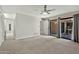 Spacious living room with carpet flooring, neutral walls, and sliding door access to outdoor space at 4525 N 66Th St # 85, Scottsdale, AZ 85251