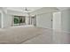 Spacious living room featuring both tile and carpet flooring, a ceiling fan, and sliding doors to backyard at 4525 N 66Th St # 85, Scottsdale, AZ 85251
