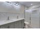 Bathroom with dual sinks, modern fixtures, and a walk-in shower with glass door at 542 E Flynn Ln, Phoenix, AZ 85012
