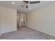 Bedroom features a ceiling fan, wood-look tile flooring, and access to an adjoining room at 542 E Flynn Ln, Phoenix, AZ 85012