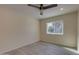 A bright bedroom features a ceiling fan, and a large window that brings in natural light at 542 E Flynn Ln, Phoenix, AZ 85012