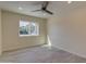 Bedroom with tiled floors, ceiling fan, and a large window for ample light at 542 E Flynn Ln, Phoenix, AZ 85012