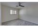 Bedroom with ceiling fan, window with plantation shutters, and modern wood-look flooring at 542 E Flynn Ln, Phoenix, AZ 85012