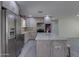 Updated kitchen featuring stainless steel appliances, granite countertops, and gray cabinets at 542 E Flynn Ln, Phoenix, AZ 85012