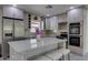 Well-equipped kitchen with a center island, stainless steel appliances, and granite countertops at 542 E Flynn Ln, Phoenix, AZ 85012