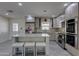 Updated kitchen boasts stainless steel appliances and a center island with barstool seating at 542 E Flynn Ln, Phoenix, AZ 85012