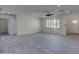 Open living room area featuring tile flooring and a large window with shutters at 542 E Flynn Ln, Phoenix, AZ 85012