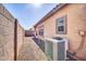 Gravel backyard has AC unit and is enclosed by block walls for privacy at 6330 W Constance Way, Laveen, AZ 85339