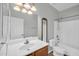 Bright bathroom featuring a shower-tub combination and a single sink vanity with a large mirror at 6330 W Constance Way, Laveen, AZ 85339